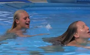 Two beautiful girls swimming and licking by the come together