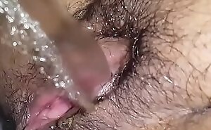 Hairy love tunnel babe pulling a piss closeup