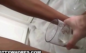 Tied up ebony honey pees in a cup and drinks it